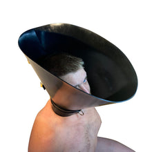 Load image into Gallery viewer, The Cone of Shame - Vilain Garçon - a heavy rubber cone of shame locked on a kneeling submissive
